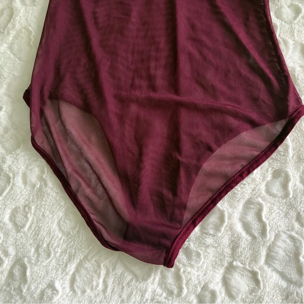 NWOT USA Vintage Burgundy Sheer Long Sleeve Bodysuit in Size Medium.